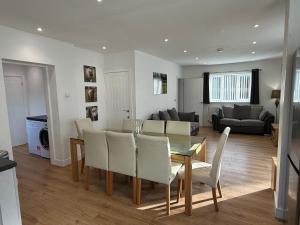 a dining room and living room with a table and chairs at The Farmhouse at Moss Bank Farm in Wrexham +22 photos