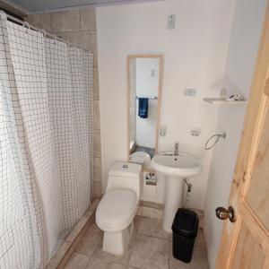 a small bathroom with a toilet and a sink at Apartamentos Las Orquideas in San Pedro