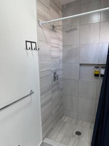 a shower with a glass door in a bathroom at Modern House with Mini-Splits in Chihuahua +19 photos