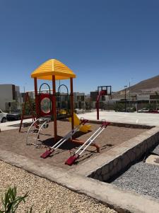 a playground with a yellow roof at Modern House with Mini-Splits in Chihuahua