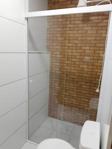 a bathroom with a glass shower with a toilet at EL Shaday in Guarujá