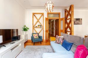 a living room with a couch and a tv at Cais Sodré Spacious Apartment in Lisbon