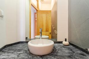 a bathroom with a large tub in the middle of the room at Cais Sodré Spacious Apartment in Lisbon +19 photos