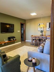 a living room with a couch and a table at Casa For Rua Torta in Gramado