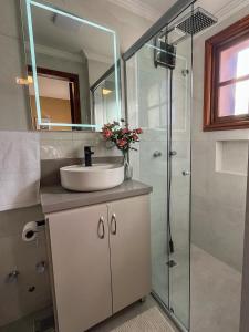 a bathroom with a sink and a shower at Casa For Rua Torta in Gramado +21 photos