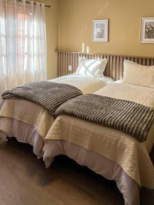 a bedroom with two beds and a window at Casa For Rua Torta in Gramado