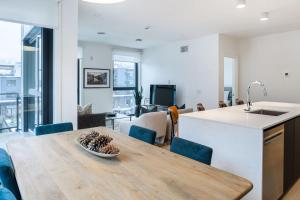 a kitchen with a table with a bowl of pine cones on it at Alpine Living - Modern 2 Bedroom Condo in Revelstoke
