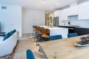 a kitchen and dining room with a table and chairs at Alpine Living - Modern 2 Bedroom Condo in Revelstoke +24 photos