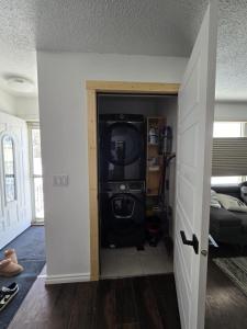 a room with a door open to a living room at Like Home in Regina
