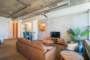 a living room with a couch and a tv at Skyline Loft Studio w City Views in Phoenix