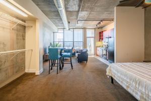 a room with a bed and a table and chairs at Skyline Loft Studio w City Views in Phoenix