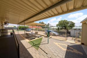 a patio with awning and a table and chairs at Squatters Cottage in Port Augusta