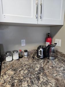 a kitchen counter with a toaster and a coffee maker on it at Like Home in Regina