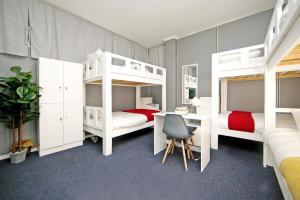 a bedroom with two bunk beds and a desk at CBD City views on 61 wale street by M&B in Cape Town