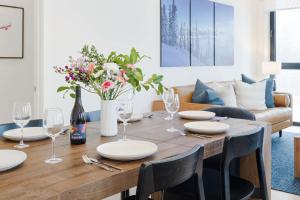 a dining room with a table with wine glasses and flowers at The View - Luxury Penthouse Condo in Revelstoke
