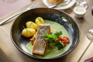 a plate of food with bread and vegetables on a table at Hôtel-Restaurant L'Auberge in Spa