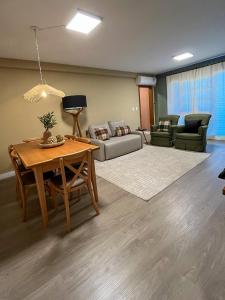 a living room with a table and a couch at Casa For Rua Torta in Gramado