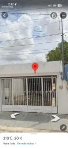 a garage door with a red sign on it at Casa pame 2026 in Mérida