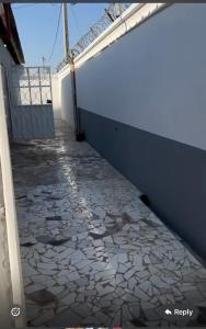 a balcony with a tile floor next to a wall at BUSUMBALA RESIDENTs in Busumbala