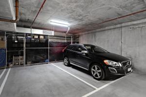 a black car parked in a parking garage at A tale awaits - just steps from trendy cafés and lively bars in Melbourne