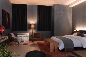 a bedroom with a bed and a desk and chairs at Mint House 70 Pine by Kasa in New York +52 photos