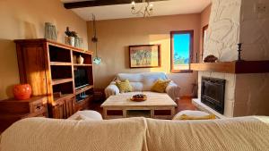 a living room with a couch and a table at LA CASA ROJA Casa privada con piscina y vistas Zona Torrox in Torrox
