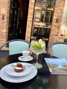 a table with a plate of food and a glass of wine at BHB Boutique House in Macedo de Cavaleiros