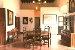 a dining room with a wooden table and chairs at Casa Centenario in Taxco de Alarcón