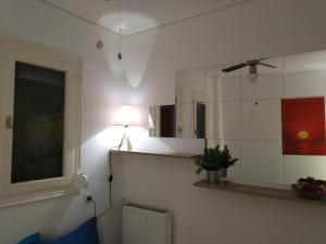a room with a mirror and a lamp on a wall at P & G Apartment in Pámfylla +47 photos
