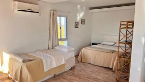 a room with two beds and a window at Rio Termal in Federación