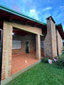 a brick house with a large patio at Casa del parque in Oberá