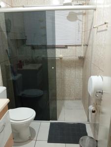 a bathroom with a shower with a toilet and a sink at Maria Hostel Brasil gru in Guarulhos