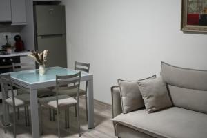 a kitchen with a table and chairs and a couch at Orikum Getaway in Orikum