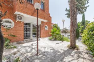 a brick building with two street lights in front of it at AYZ Joaquín Pol - Auto check-in property in Madrid