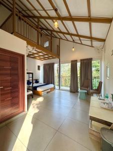 a large room with a bed and a balcony at Hayashi Resort in Meppādi