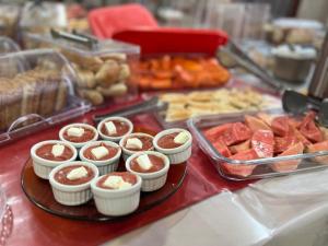 a table with a tray of desserts and pastries at Hotel San Remo in Ubá