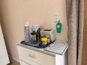 a counter top with a coffee maker and a toaster at Lilys guest house in Auckland