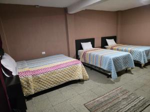 a room with two beds at Hotel Fontana Real in Quetzaltenango