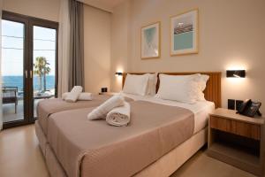 a bedroom with two beds with a view of the ocean at Akti Vigla Premium in Mytilene