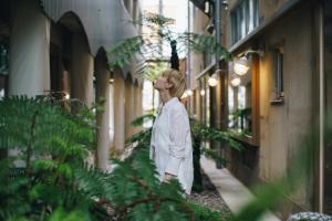 a woman walking down a street in an alley at KOTOBUKI Hotel in Kanoya