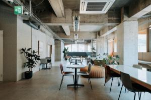 a large room with tables and chairs in it at KOTOBUKI Hotel in Kanoya