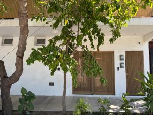 a building with two trees in front of it at Habitat in Barra de Navidad