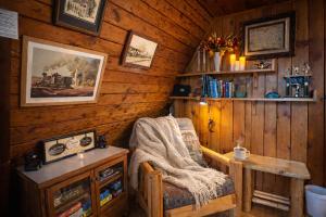 a room with a chair and a table in a cabin at Serenity A Frame in Ashford
