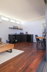 a living room with a table and a wooden floor at Buller Wines in Rutherglen
