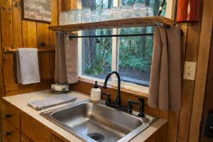 a kitchen with a sink and a window at Serenity A Frame in Ashford +15 photos