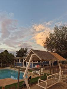 a house with a swing and a swimming pool at Casa Montes Valle Alegre in Quintero