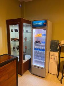 a refrigerator filled with bottles of water in a room at Costumbres Argentinas Dobles En suite in Avellaneda