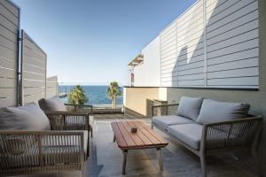 a patio with chairs and a couch and a table at Akti Vigla Premium in Mytilene