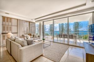 a living room with a couch and a table at Sea Pearl A1 Beach Resort in Mooloolaba