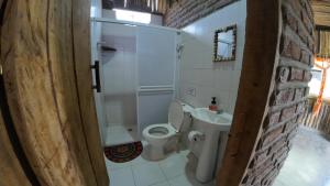 a small bathroom with a toilet and a shower at Casa Grulla in Santa Marta